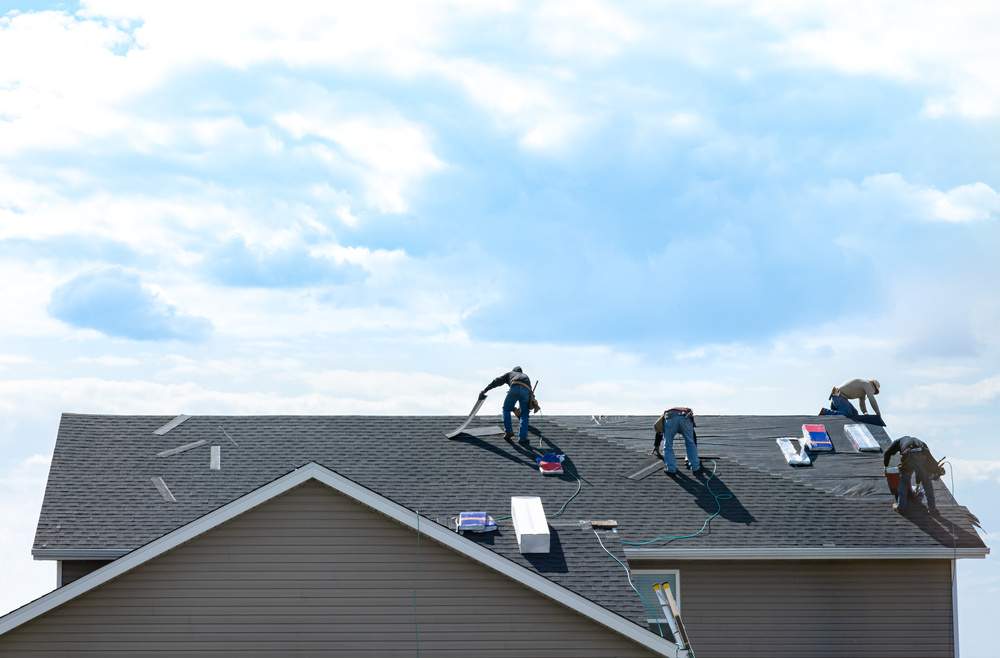 team of roofing professionals working