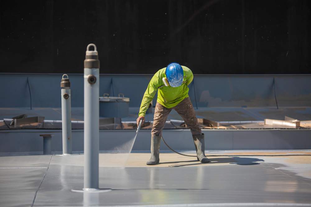 Worker Spraying Protective Coating