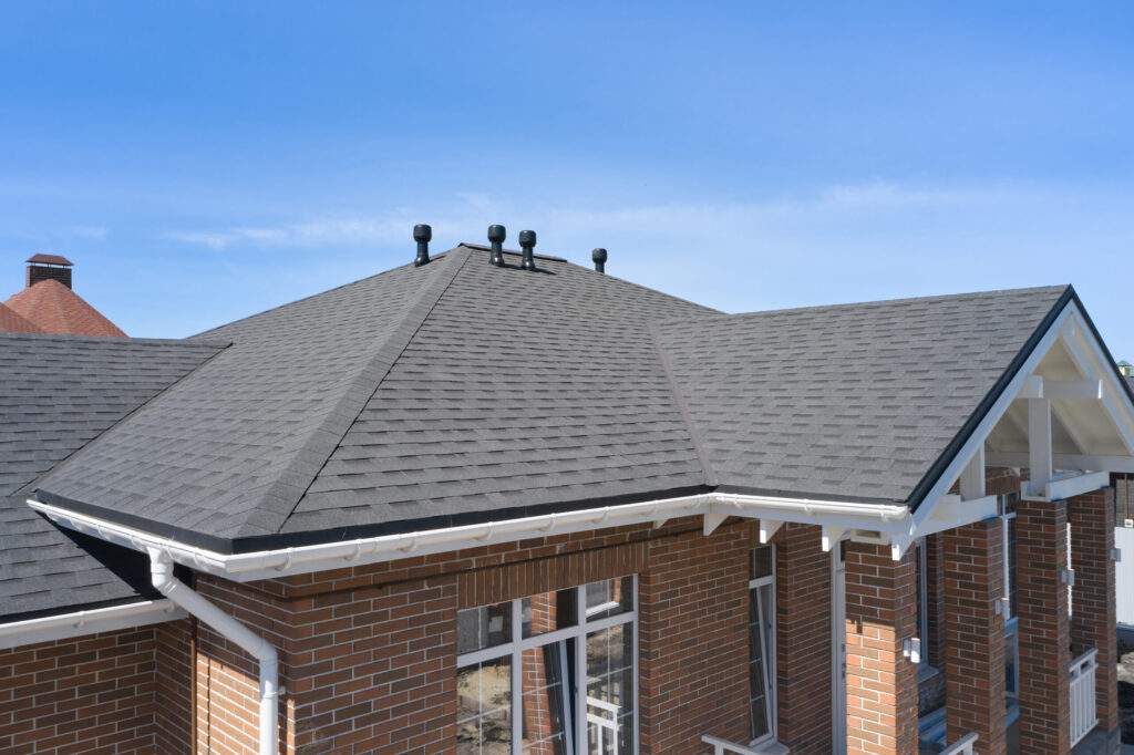 Luxury house roof with asphalt shingles.